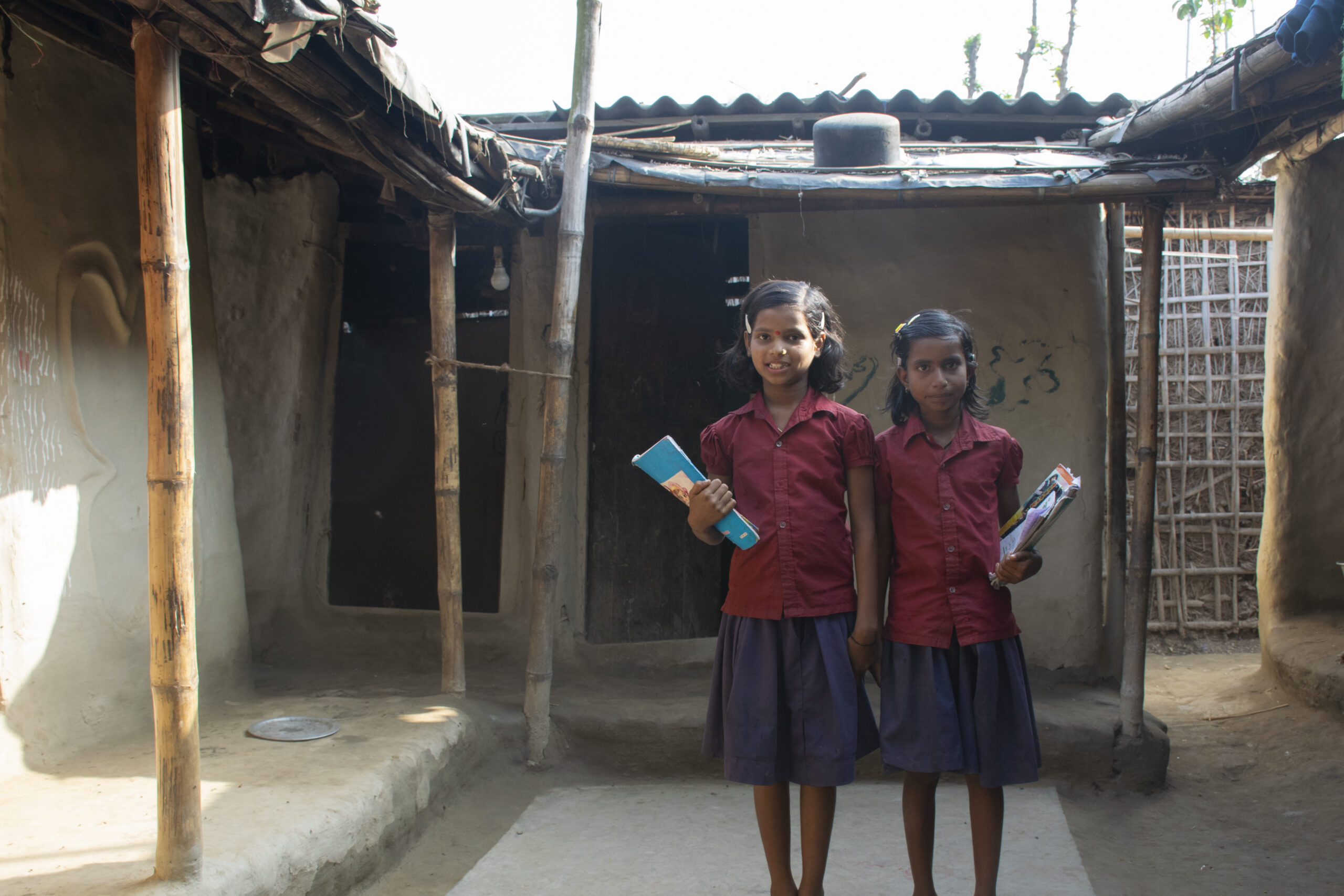 portrait-young-children-school-uniform-holding-books